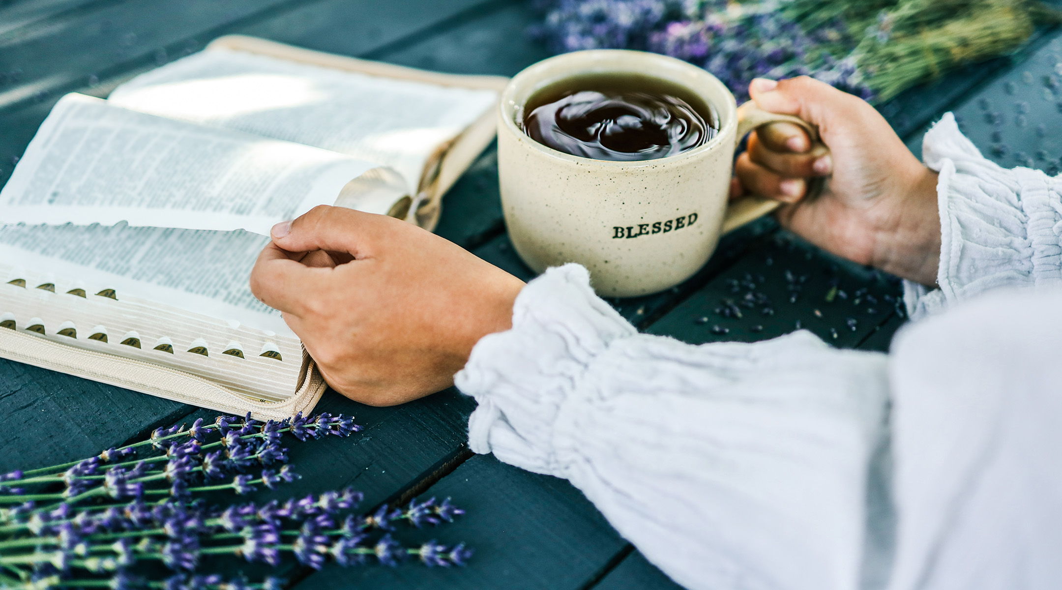 Journal and Bible open on a table with morning coffee